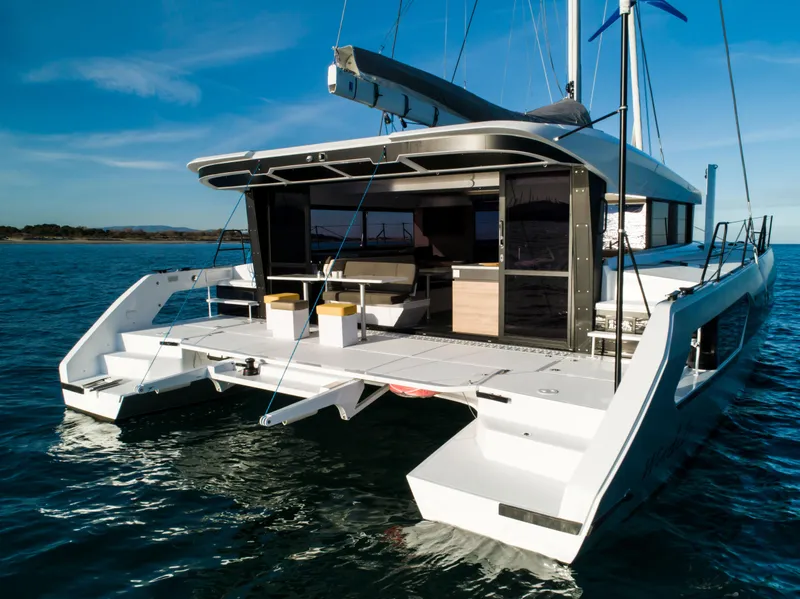 Slide: The Image of Windelo 54 catamaran 2025 model on calm waters with open deck and modern design. - 31
