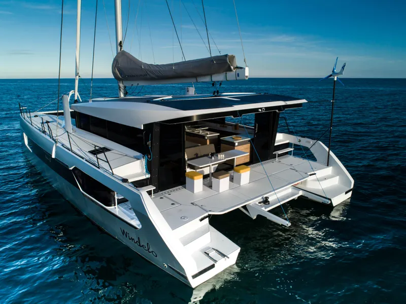 Slide: The Image of Windelo 54 catamaran 2025 model sailing on open sea with modern design. - 32