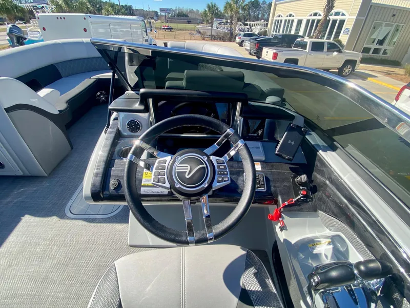 Slide: The Image of 2023 Vanderbilt 700T boat cockpit with steering wheel and control panel. - 16