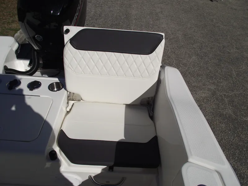 Slide: The Image of 2024 Bayliner CC20 boat interior with rod holders and cup holder. - 13