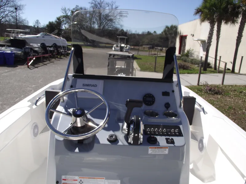 Slide: The Image of 2024 Bayliner CC20 boat dashboard with steering wheel, throttle, and Simrad navigation system. - 19
