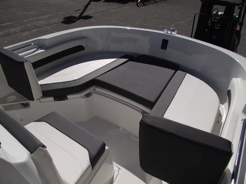 Slide: The Image of Bayliner CC20 2024 boat storage compartment with cushioned seat. - 28