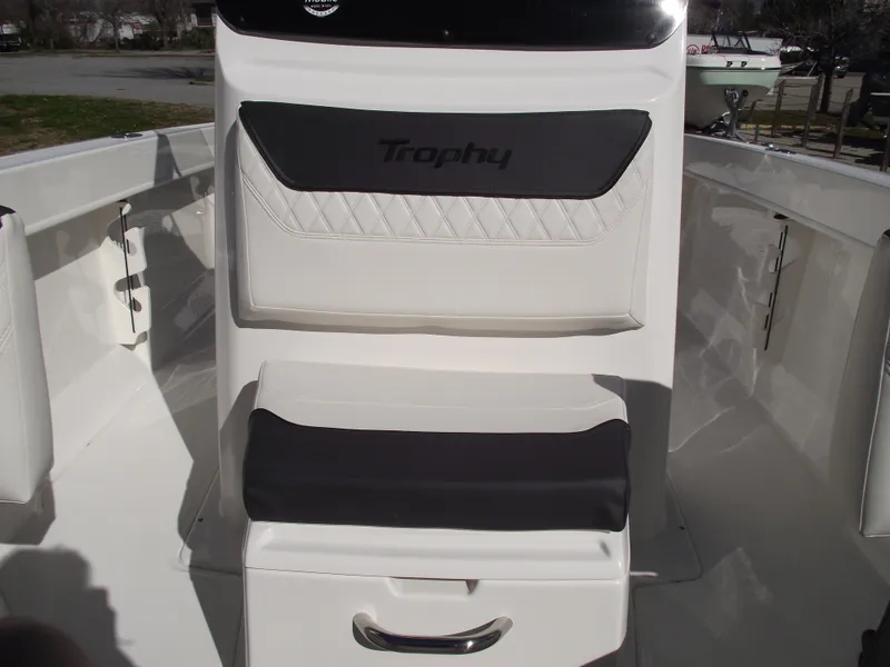 Slide: The Image of 2024 Bayliner CC20 boat interior with cushioned seating in a marina. - 29