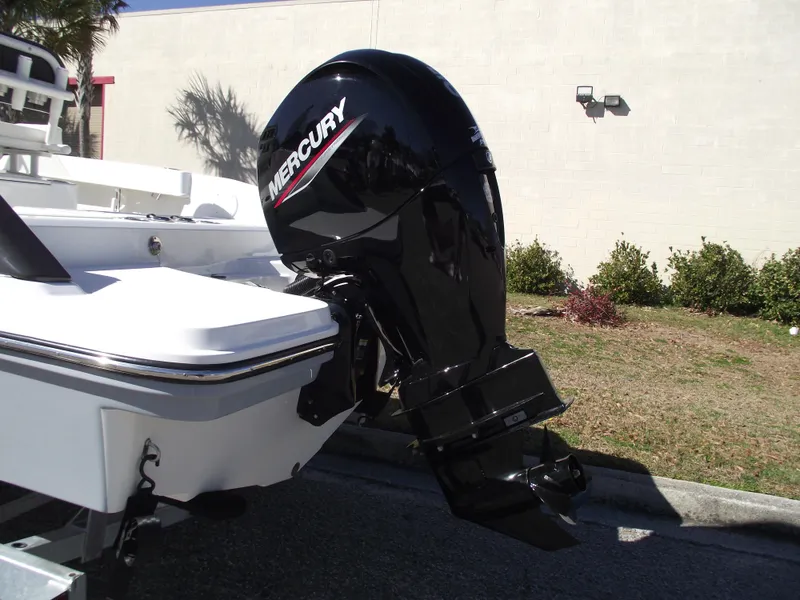 Slide: The Image of 2024 Bayliner CC20 boat interior with storage compartments and Mercury engine. - 5