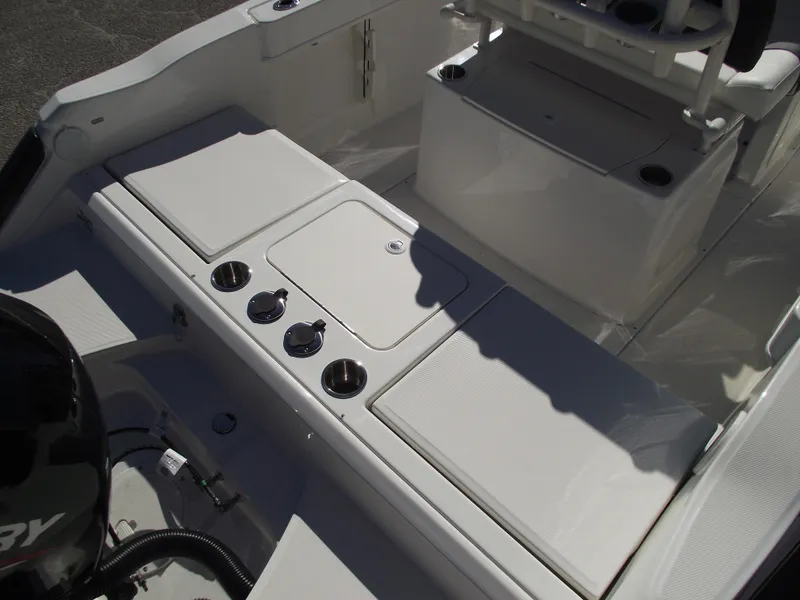 Slide: The Image of 2024 Bayliner CC20 boat stern with outboard motor and storage compartments. - 7