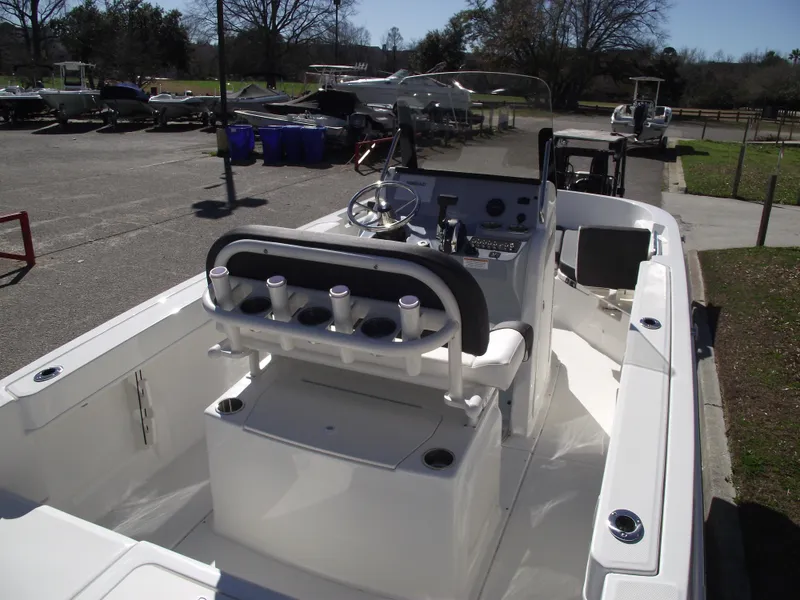 Slide: The Image of 2024 Bayliner CC20 boat with cushioned seating and storage compartment. - 8