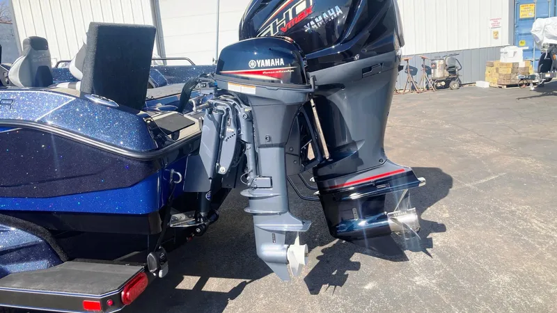 Slide: The Image of 2024 Skeeter WXR 2060 F boat with Yamaha outboard motors in a parking lot. - 2