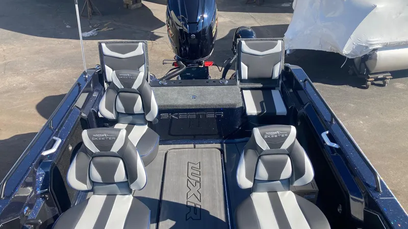 Slide: The Image of 2024 Skeeter WXR 2060 F boat interior with four seats and outboard motor. - 6