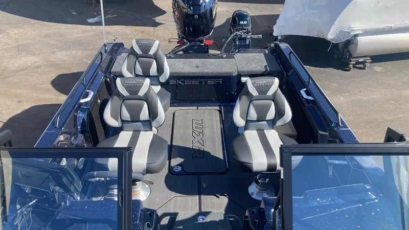 Slide: The Image of 2024 Skeeter WXR 2060 F boat interior with four seats and motor. - 7