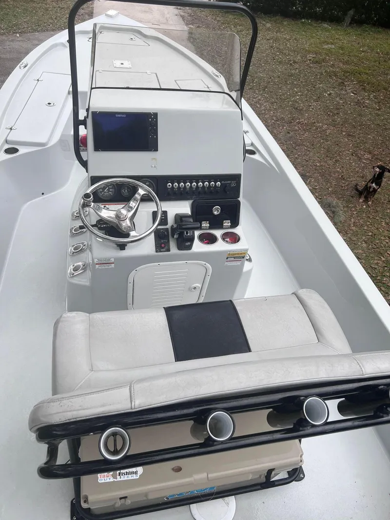Slide: The Image of 2020 Blazer 2200 Fisherman boat interior with steering console and seating. - 4