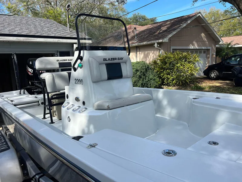 Slide: The Image of 2020 Blazer 2200 Fisherman boat in a residential driveway. - 5
