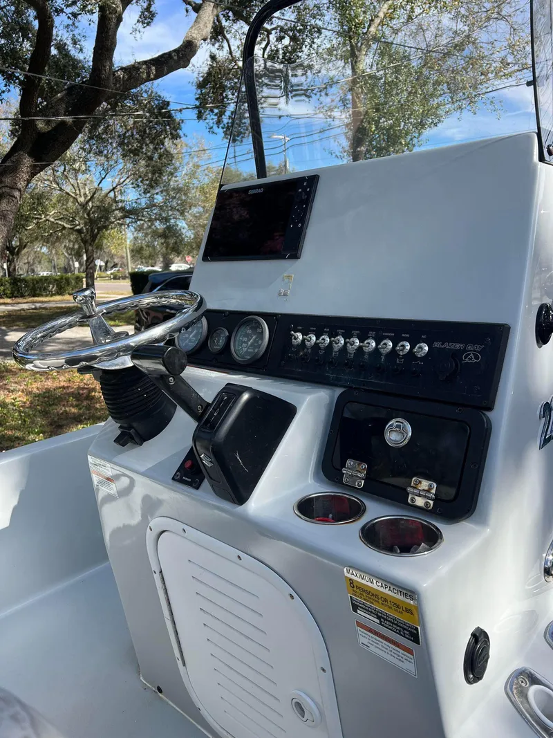 Slide: The Image of 2020 Blazer 2200 Fisherman boat console with steering wheel and control panel. - 8