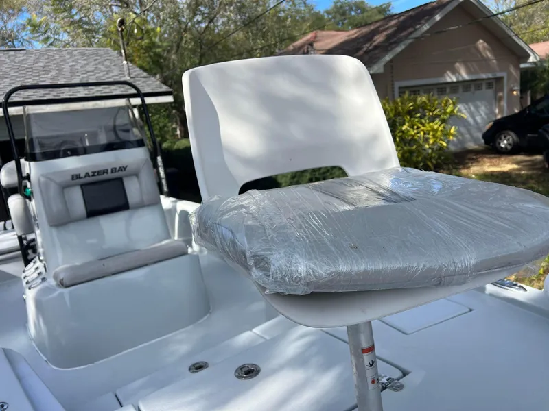 Slide: The Image of 2020 Blazer 2200 Fisherman boat with wrapped seat in residential driveway. - 9