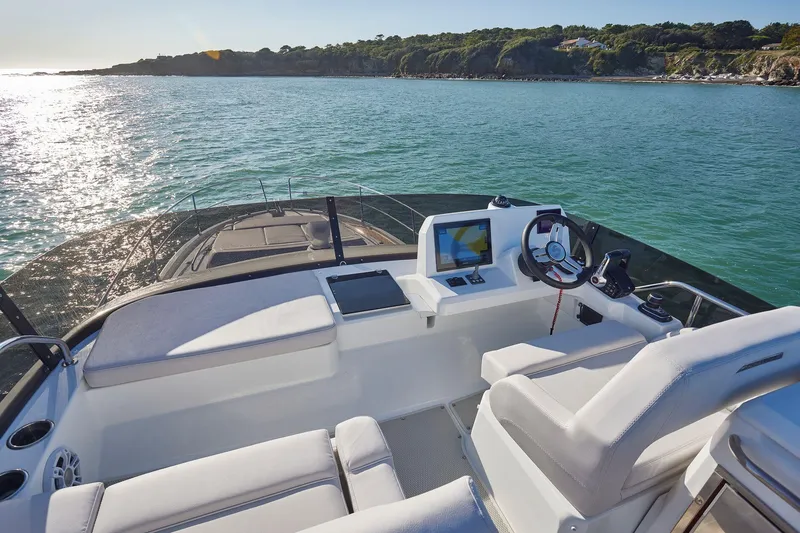 Slide: The Image of 2025 Beneteau Antares 12 boat cockpit with ocean view and modern navigation equipment. - 10