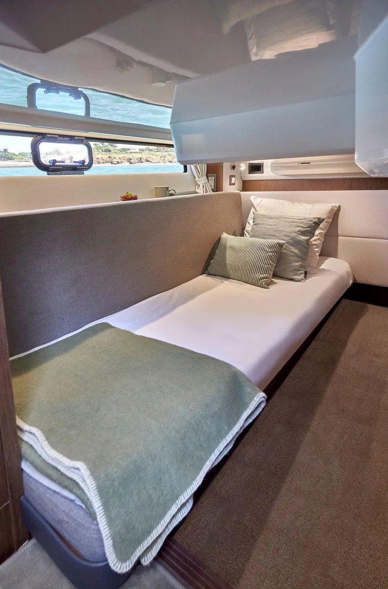 Slide: The Image of 2025 Beneteau Antares 12 cabin interior with bed and pillows. - 6