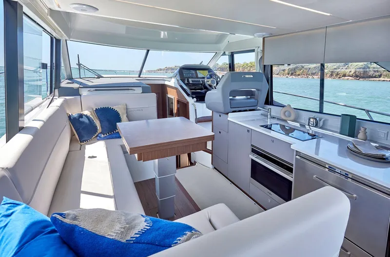 Slide: The Image of Interior of 2025 Beneteau Antares 12 yacht with modern kitchen and seating area. - 7