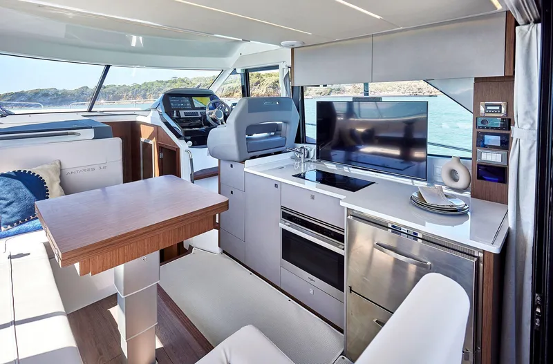 Slide: The Image of Modern interior of 2025 Beneteau Antares 12 yacht with kitchen and dining area. - 8