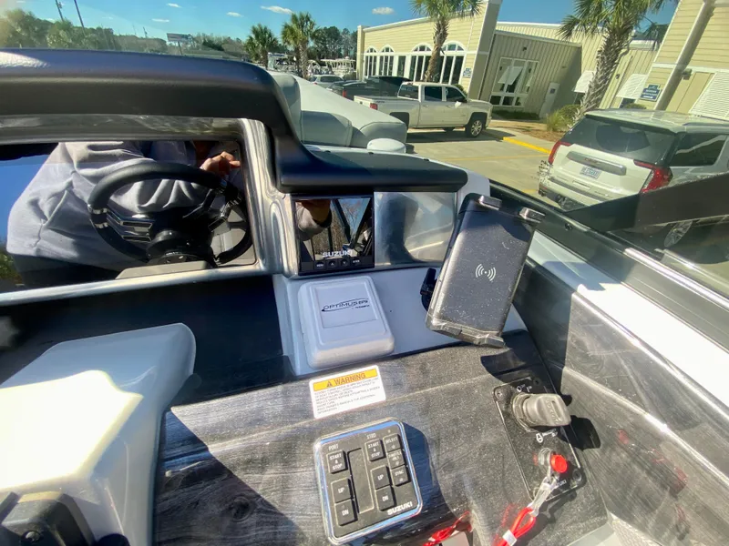Slide: The Image of Control panel of a 2023 Vanderbilt 700T boat with steering wheel and dashboard. - 17