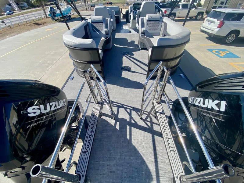Slide: The Image of 2023 Vanderbilt 700T boat with dual Suzuki engines, spacious seating, and modern design. - 7