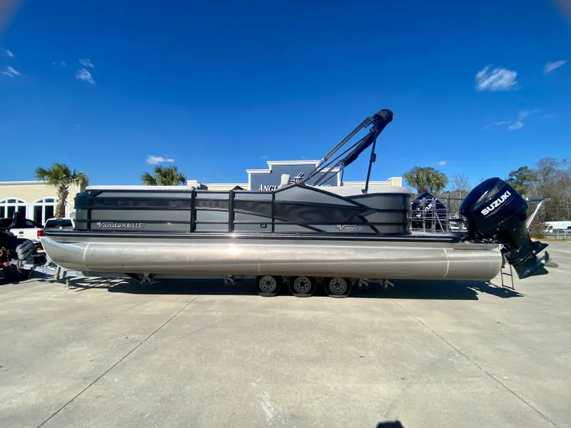 Slide: The Image of 2023 Vanderbilt 700T pontoon boat with Suzuki outboard motor. - 0