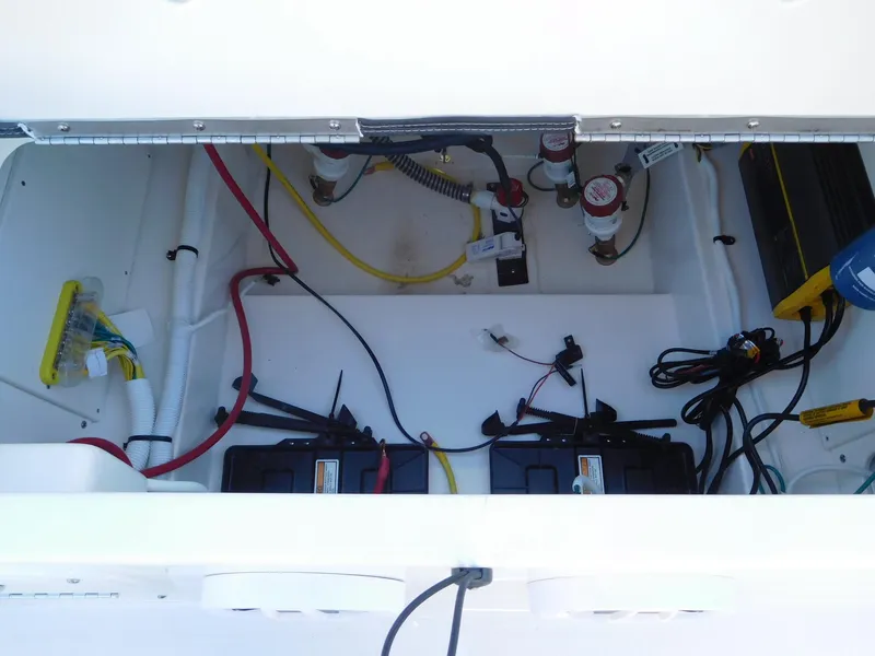 Slide: The Image of 2024 Robalo 226 Cayman boat battery compartment with wiring and components. - 15