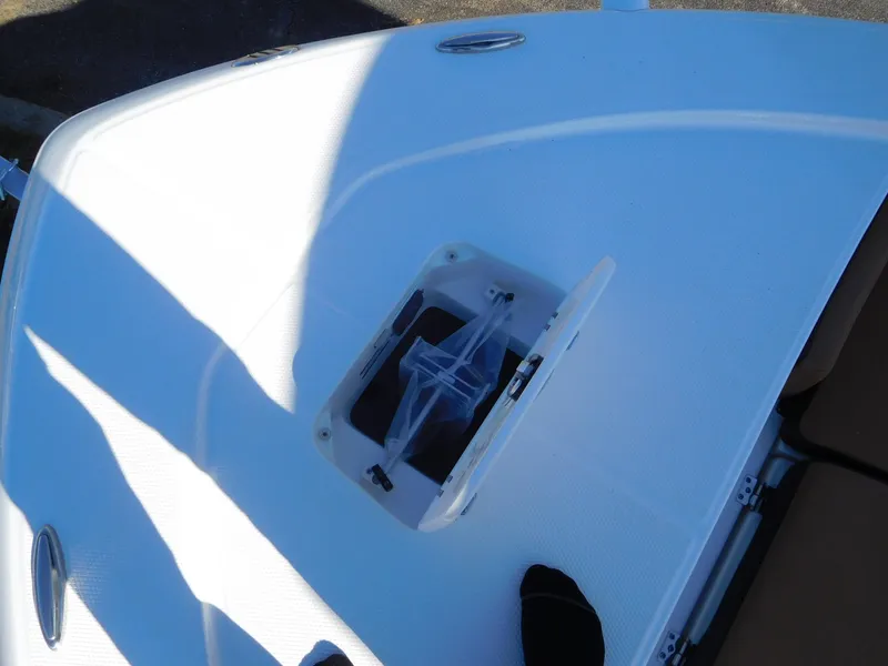 Slide: The Image of 2024 Robalo 226 Cayman boat deck with open storage compartment. - 17