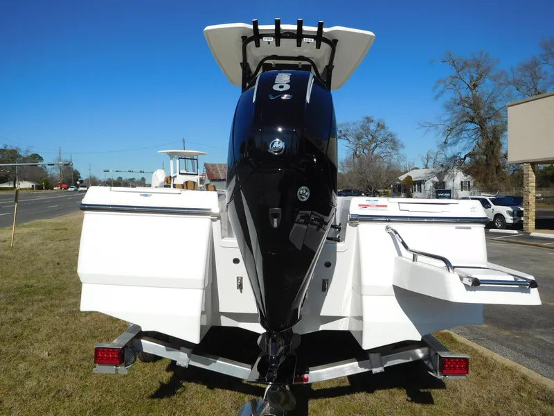 Slide: The Image of 2024 Robalo 226 Cayman boat rear view with outboard motor on trailer. - 21