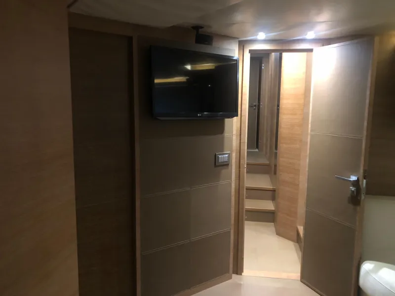 Slide: The Image of Interior of 2012 Monte Carlo Yachts 76 with TV and wooden paneling. - 21