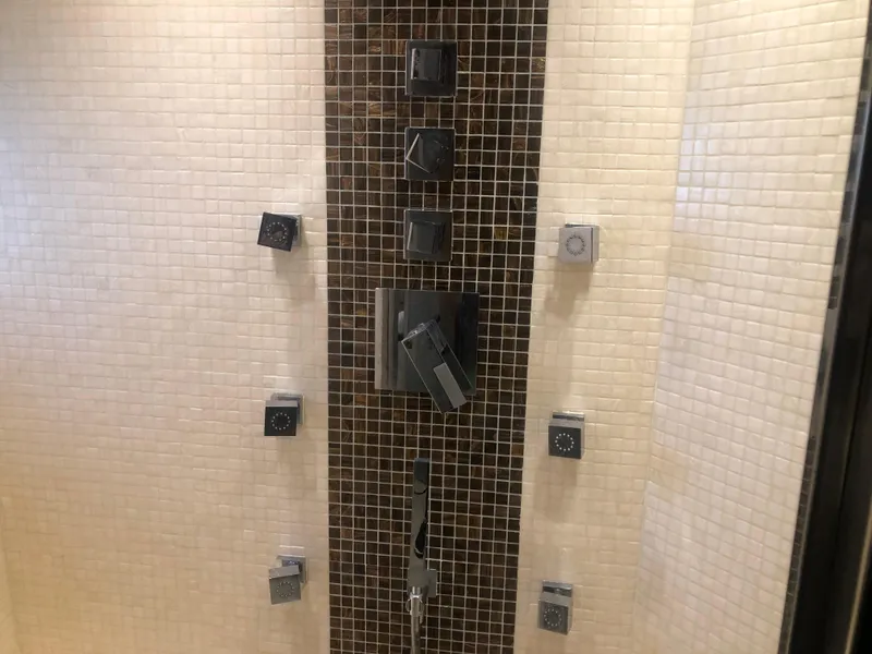 Slide: The Image of Luxurious shower system in a 2012 Monte Carlo Yachts 76, featuring multiple jets and modern design. - 22