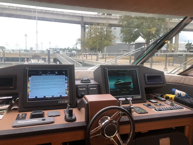 Slide: The Image of Helm station of 2012 Monte Carlo Yachts 76 with navigation screens and controls. - 36