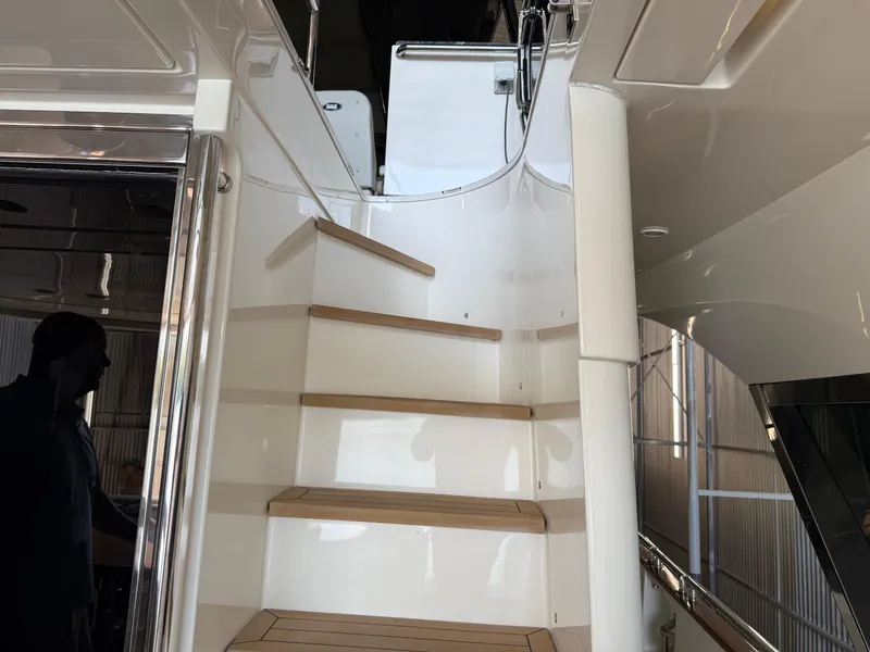 Slide: The Image of Staircase on 2012 Monte Carlo Yachts 76, featuring sleek design and wooden steps. - 41
