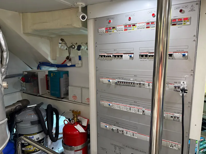 Slide: The Image of Electrical control panel in 2012 Monte Carlo Yachts 76 engine room, featuring safety equipment. - 49