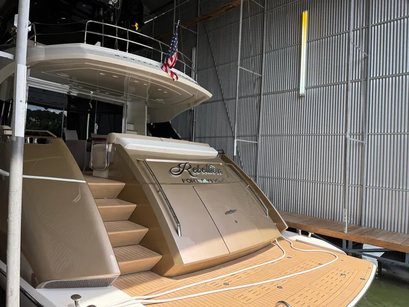 Slide: The Image of Luxury Monte Carlo Yachts 76, 2012 model, docked with elegant design and American flag. - 8