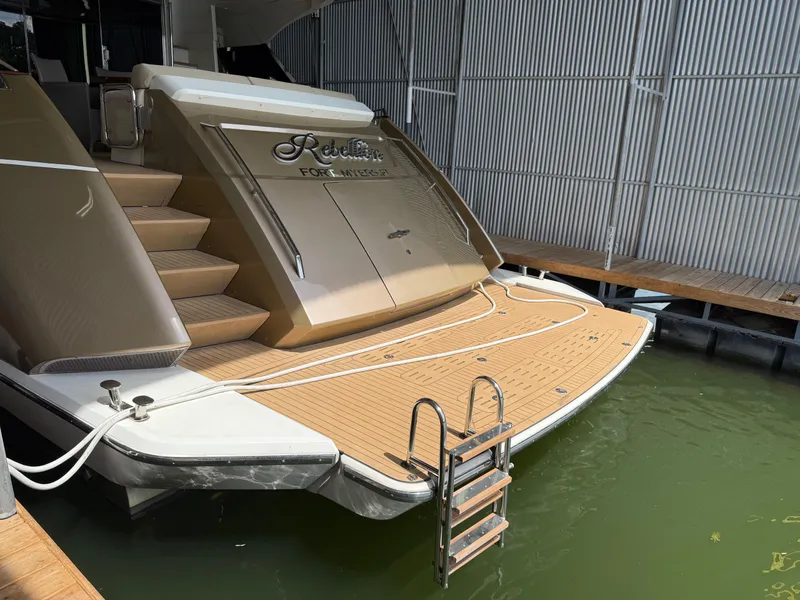 Slide: The Image of Luxury Monte Carlo Yachts 76, 2012 model, docked with elegant teak deck and ladder. - 9