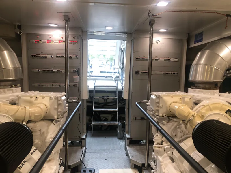 Slide: The Image of Engine room of a 2012 Monte Carlo Yachts 76 with dual engines and control panels. - 15