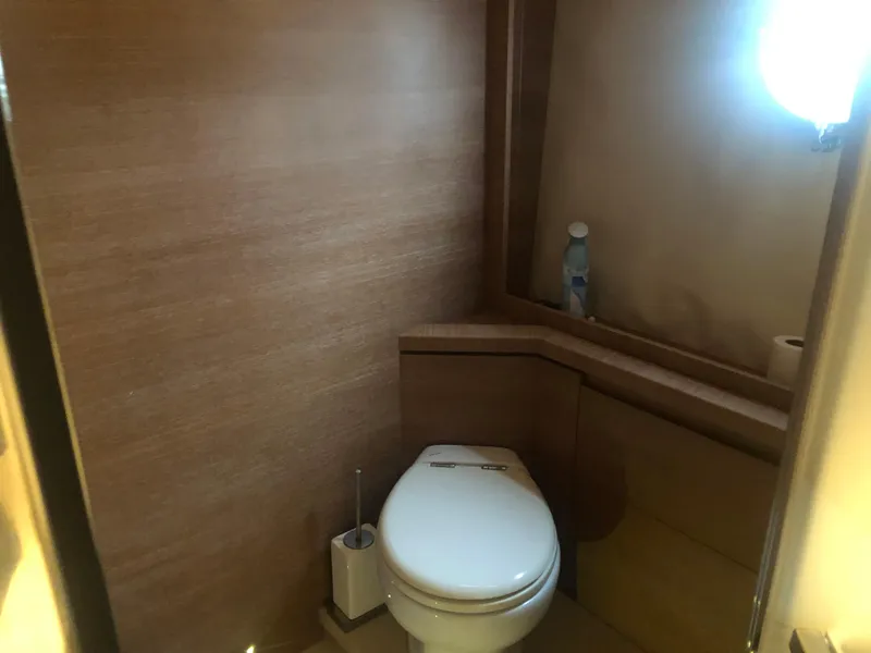 Slide: The Image of 2012 Monte Carlo Yachts 76 bathroom with modern toilet and wooden interior. - 23