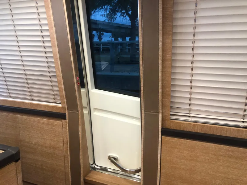 Slide: The Image of Interior door of 2012 Monte Carlo Yachts 76 with wooden paneling and blinds. - 28