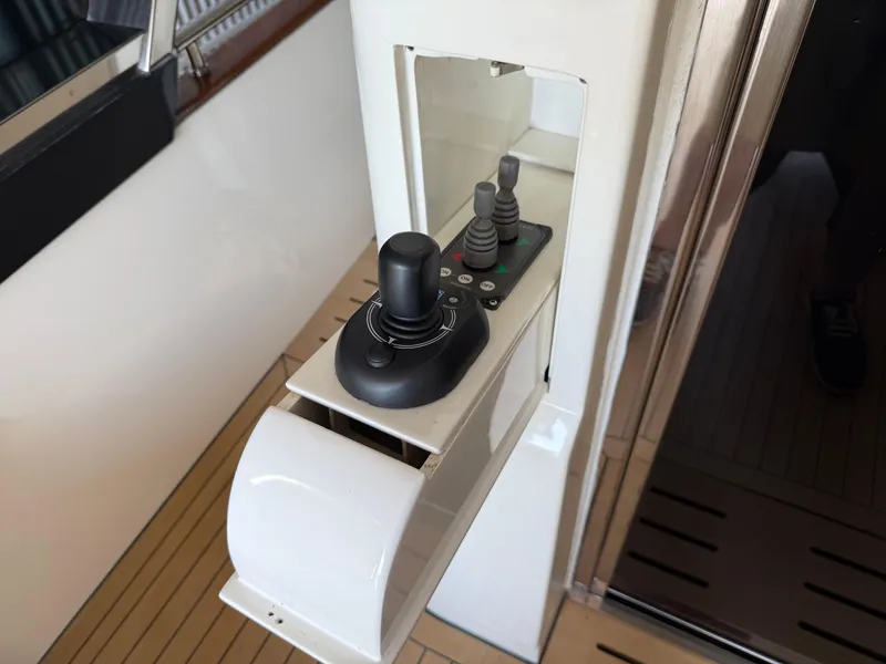 Slide: The Image of Control panel of a 2012 Monte Carlo Yachts 76, featuring joystick and switches. - 43