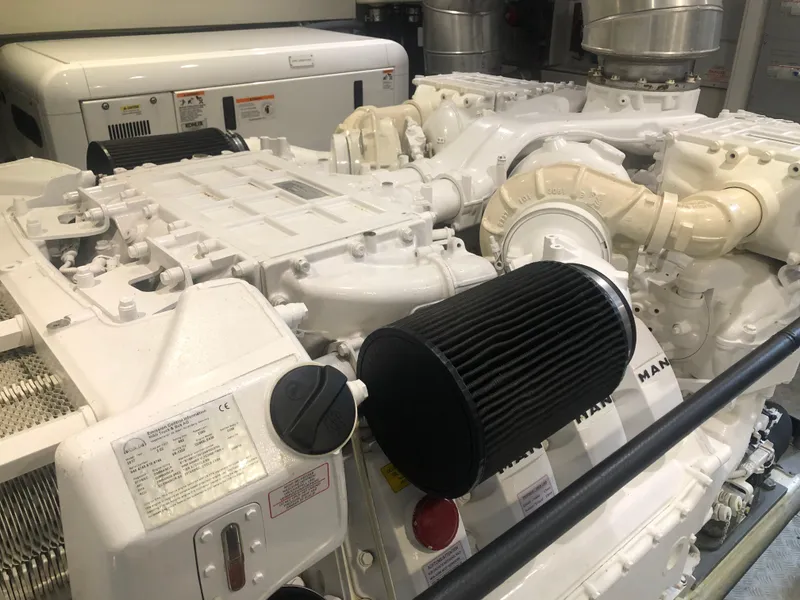 Slide: The Image of Engine room of a 2012 Monte Carlo Yachts 76, showcasing the yacht's powerful engine. - 52