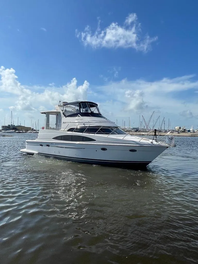 Slide: The Image of 2001 Carver 444 Cockpit Motor Yacht on calm water under blue sky. - 0