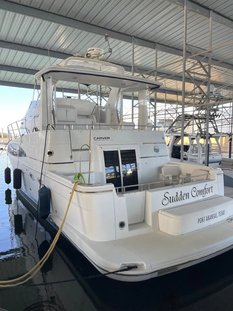 Slide: The Image of 2001 Carver 444 Cockpit Motor Yacht docked in covered marina. - 10