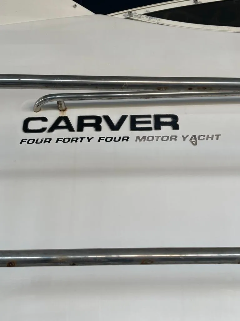 Slide: The Image of 2001 Carver 444 Cockpit Motor Yacht logo on white surface. - 13