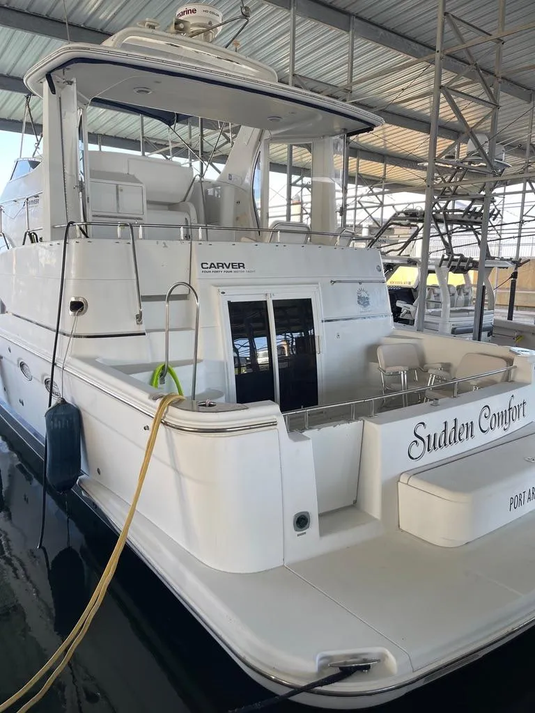Slide: The Image of 2001 Carver 444 Cockpit Motor Yacht in marina, named "Sudden Comfort". - 17