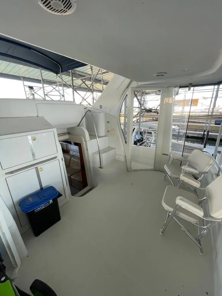 Slide: The Image of 2001 Carver 444 Cockpit Motor Yacht interior with seating and storage. - 26