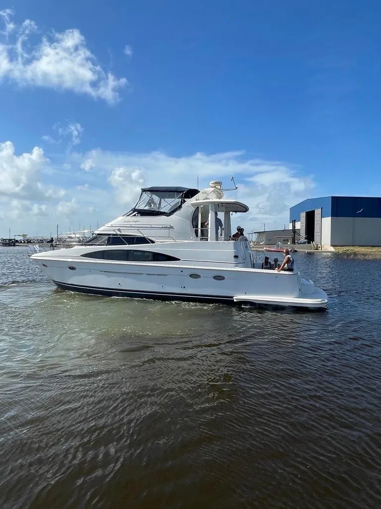 Slide: The Image of 2001 Carver 444 Cockpit Motor Yacht cruising on a sunny day. - 3