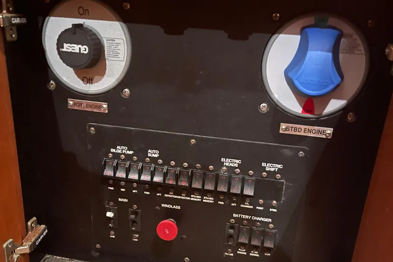 Slide: The Image of Control panel of a 2001 Carver 444 Cockpit Motor Yacht, featuring engine and electrical switches. - 31