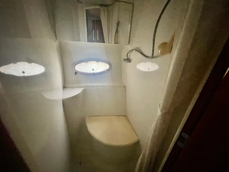 Slide: The Image of Compact bathroom in 2001 Carver 444 Cockpit Motor Yacht with shower and porthole. - 39