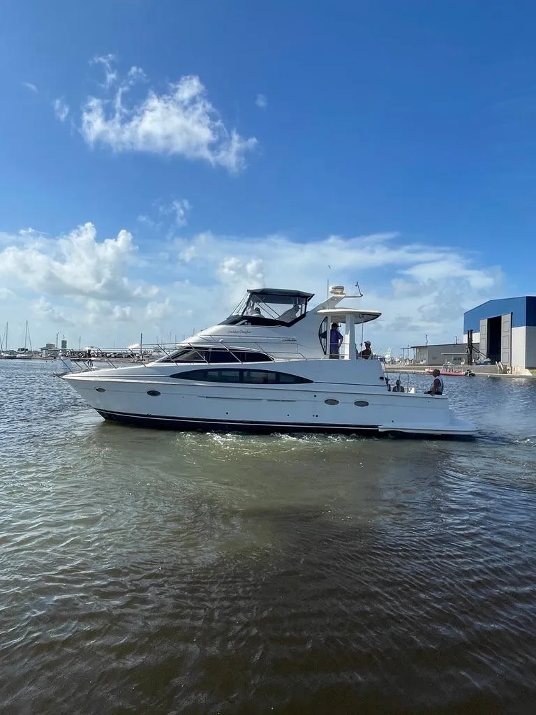 Slide: The Image of 2001 Carver 444 Cockpit Motor Yacht cruising on a sunny day. - 4