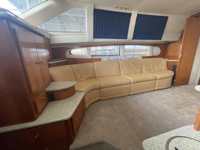 Slide: The Image of Interior of 2001 Carver 444 Cockpit Motor Yacht with beige leather sofa and wood cabinetry. - 48