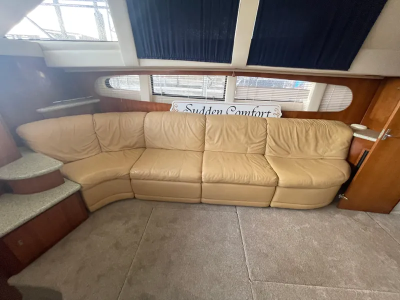 Slide: The Image of Luxurious interior of 2001 Carver 444 Cockpit Motor Yacht with beige leather sofa. - 49